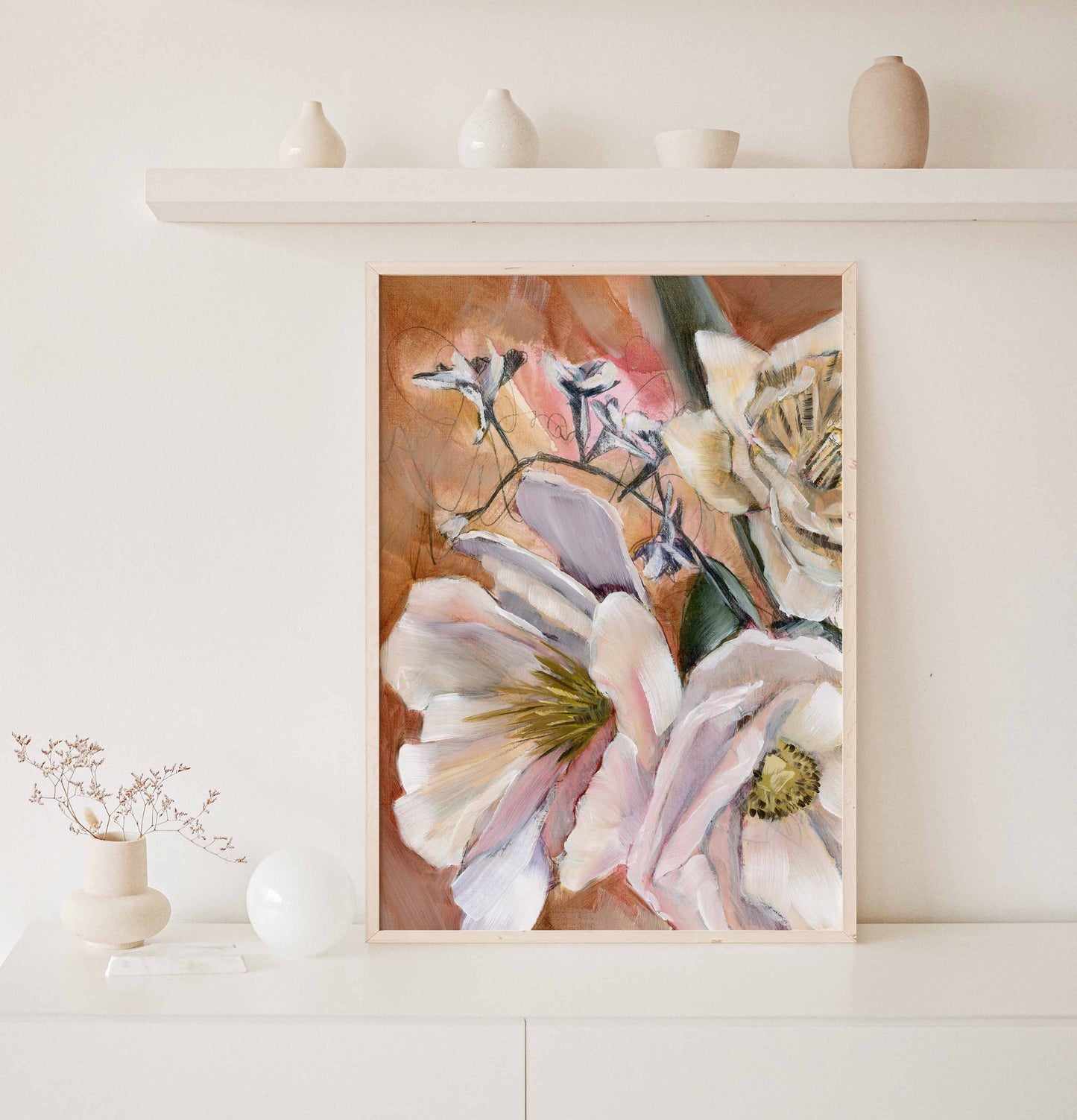 floral art print in a light frame on console